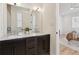 Elegant bathroom featuring a double sink vanity, marble countertop, and a view into the main bedroom at 260 Miller Reed Se Ave, Atlanta, GA 30315
