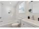 Clean white bathroom with tub and shower combination, plus modern vanity and fixtures at 260 Miller Reed Se Ave, Atlanta, GA 30315