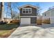 Rear exterior view of newly built home with a detached garage and a concrete driveway at 260 Miller Reed Se Ave, Atlanta, GA 30315