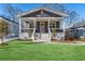 Charming home featuring a covered front porch, gray siding, and a well-maintained green lawn at 260 Miller Reed Se Ave, Atlanta, GA 30315