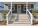 Close up of the gray home's front porch featuring a light-gray front door and white wood stairs at 260 Miller Reed Se Ave, Atlanta, GA 30315