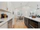 Open concept kitchen with hardwood floors leads into a dining area with a modern chandelier and a view of the living room at 260 Miller Reed Se Ave, Atlanta, GA 30315
