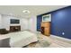 Finished basement area with TV, light wood floors, and adjacent seating at 625 Aunt Lucy Sw Ln # 34/19, Smyrna, GA 30082