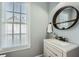 Bathroom features a round mirror, grey vanity, white countertops, and a large window at 625 Aunt Lucy Sw Ln # 34/19, Smyrna, GA 30082