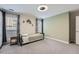 Neutral bedroom featuring a simple bed, gray carpet and a ceiling fan with windows providing natural light at 625 Aunt Lucy Sw Ln # 34/19, Smyrna, GA 30082