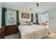 Comfortable bedroom with green curtains, ensuite bathroom and ample natural light at 625 Aunt Lucy Sw Ln # 34/19, Smyrna, GA 30082