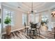 Breakfast nook features a modern chandelier, a glass table with seating for four, and natural light at 625 Aunt Lucy Sw Ln # 34/19, Smyrna, GA 30082