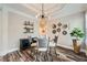 Modern dining area with a unique chandelier, decorative wall art, and wood-look flooring at 625 Aunt Lucy Sw Ln # 34/19, Smyrna, GA 30082