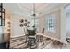 Bright dining area with modern chandelier, stylish table setting, and wood-look flooring at 625 Aunt Lucy Sw Ln # 34/19, Smyrna, GA 30082