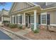 Charming front entrance of home with stone accents, manicured landscaping, and inviting blue rocking chair at 625 Aunt Lucy Sw Ln # 34/19, Smyrna, GA 30082