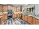 Updated kitchen with stainless steel appliances, wooden cabinets, granite counters, and hardwood floors at 625 Aunt Lucy Sw Ln # 34/19, Smyrna, GA 30082