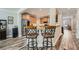 An open concept kitchen features a granite counter island with two stools and stainless steel appliances at 625 Aunt Lucy Sw Ln # 34/19, Smyrna, GA 30082