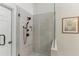 Close-up of the clear glass shower featuring a matte black shower head and tile surround at 3520 Bethwicke Dr, Cumming, GA 30040