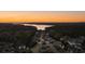 Scenic aerial view of a lakeside neighborhood with mature trees at sunset at 520 Waterside Ct, Canton, GA 30114