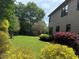 Lush backyard featuring vibrant plants, a well-maintained lawn, and mature trees, creating a serene outdoor space at 520 Waterside Ct, Canton, GA 30114