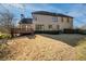 Backyard with a wood deck and mature trees; the lawn needs some TLC but offers outdoor living and green space at 520 Waterside Ct, Canton, GA 30114