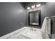 Stylish half bathroom with modern fixtures, wainscoting, and a decorative mirror at 520 Waterside Ct, Canton, GA 30114