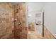Tiled shower and bathroom featuring decorative accents, complemented by brick-style wall accents for a warm, textured finish at 520 Waterside Ct, Canton, GA 30114