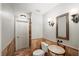Charming half bathroom with a unique sink, decorative lighting, and brick-style tiling for a rustic and stylish look at 520 Waterside Ct, Canton, GA 30114