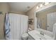 Standard bathroom with white sink and toilet, with an ordinary shower curtain at 520 Waterside Ct, Canton, GA 30114