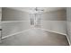 Empty bedroom with neutral colored walls, trim, and carpet, featuring windows at 520 Waterside Ct, Canton, GA 30114