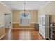 Formal dining room with hardwood floors, a chandelier, and classic moldings at 520 Waterside Ct, Canton, GA 30114
