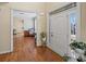 Bright foyer with hardwood floors, white door, and views into adjacent living spaces at 520 Waterside Ct, Canton, GA 30114
