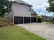 Three-car garage with black doors and a spacious driveway, offering ample parking and storage at 520 Waterside Ct, Canton, GA 30114