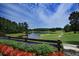 Scenic view of the golf course and pond with colorful flowers in the foreground at 520 Waterside Ct, Canton, GA 30114