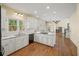 Bright kitchen with white cabinets, granite countertops, stainless appliances, and hardwood floors at 520 Waterside Ct, Canton, GA 30114