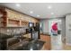 Kitchen with dark granite countertop, stainless steel appliances, tile backsplash, and light wood cabinets at 520 Waterside Ct, Canton, GA 30114