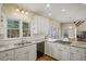 Bright kitchen showcasing white cabinets, granite countertops, stainless steel appliances, and a garden view at 520 Waterside Ct, Canton, GA 30114