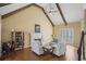 Inviting living room with vaulted ceilings, exposed beams, a cozy fireplace, and hardwood floors at 520 Waterside Ct, Canton, GA 30114