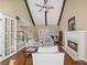 Bright living room boasts high ceilings, exposed beams, fireplace and abundant natural light at 520 Waterside Ct, Canton, GA 30114