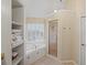 Elegant bathroom featuring a tub, glass enclosed shower, and built-in storage shelves at 520 Waterside Ct, Canton, GA 30114