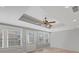 Bright sunroom with multiple windows, tile flooring, and a tray ceiling with a fan, perfect for relaxing or entertaining at 520 Waterside Ct, Canton, GA 30114