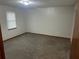 Neutral bedroom featuring carpeted floors, window, and closet space at 1281 Bugle Ct, Hampton, GA 30228