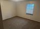 Cozy bedroom featuring neutral walls, carpet flooring, and a window that allows for natural light at 1281 Bugle Ct, Hampton, GA 30228