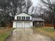 Charming home featuring a two-car garage, neutral siding, and a welcoming front yard at 1281 Bugle Ct, Hampton, GA 30228