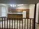 View of the kitchen from the living room featuring wood cabinets and open floorplan at 1281 Bugle Ct, Hampton, GA 30228