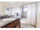 Granite vanity in renovated bathroom with shower-tub combo and modern fixtures at 1721 Streamview Se Dr, Atlanta, GA 30316