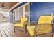 Charming covered front porch with stained wood floors and comfortable wicker seating with bright yellow cushions at 1721 Streamview Se Dr, Atlanta, GA 30316