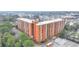 Aerial view of a brick apartment building with a parking lot and lush green trees at 300 Johnson Ferry Ne Rd # B411, Atlanta, GA 30328