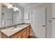 Granite counters accent this bathroom featuring a spacious vanity and large mirror at 300 Johnson Ferry Ne Rd # B411, Atlanta, GA 30328