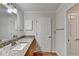 Bathroom featuring a granite vanity countertop, wood cabinets, and a large mirror at 300 Johnson Ferry Ne Rd # B411, Atlanta, GA 30328