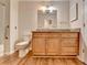 Bathroom featuring wood-look flooring, a light wood vanity, and granite countertops at 300 Johnson Ferry Ne Rd # B411, Atlanta, GA 30328