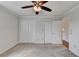 Bedroom showcasing a ceiling fan, neutral carpet and walls, and double closets at 300 Johnson Ferry Ne Rd # B411, Atlanta, GA 30328