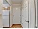 Inviting entryway featuring white doors, wood-look flooring, and a glimpse of the kitchen at 300 Johnson Ferry Ne Rd # B411, Atlanta, GA 30328