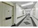 Well-lit hallway with neutral walls and patterned carpet leading to the exit at 300 Johnson Ferry Ne Rd # B411, Atlanta, GA 30328