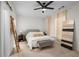 Bright bedroom with neutral tones, decorative ladder and ceiling fan at 100 Brickworks Ne Cir # 104, Atlanta, GA 30307